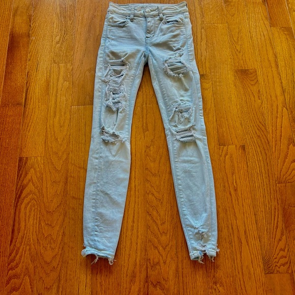 AMERICAN EAGLE NEXT LEVEL STRETCH DISTRESSED ROW HEM MID RISE LIGHT BLUE SIZE 00 - Picture 1 of 6